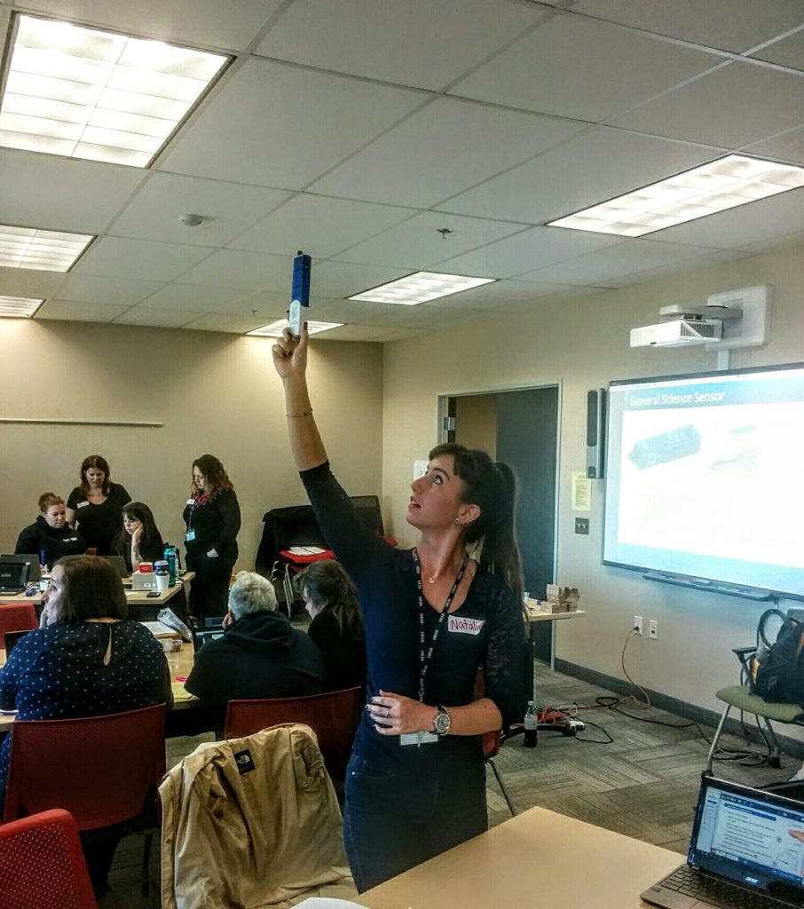 Reaching towards the ceiling a participant at the Halifax regional district school board investigates variations in light levels throughout the room.